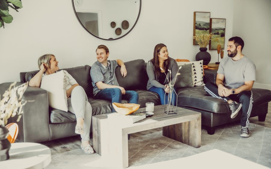 Four people having an upbeat conversation on a couch