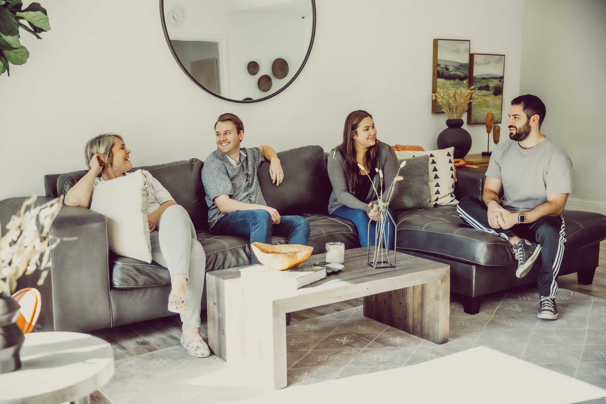 Four people having an upbeat conversation on a couch