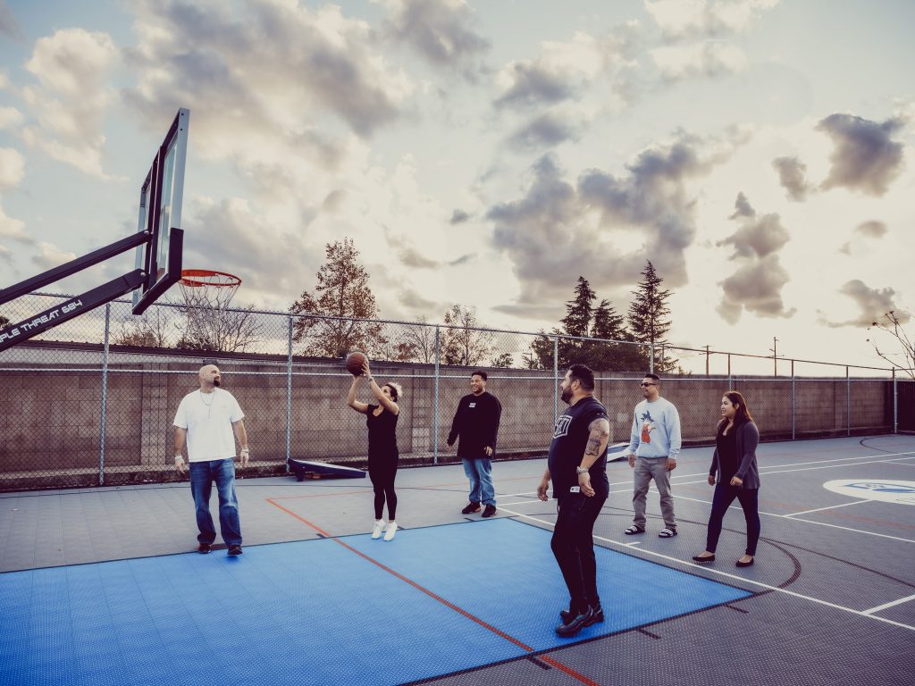 A group of people playing basketball on a court