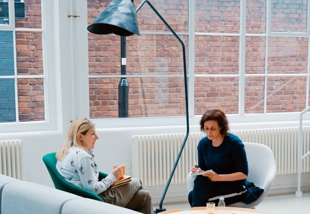 Woman drinking tea and talking to a therapist